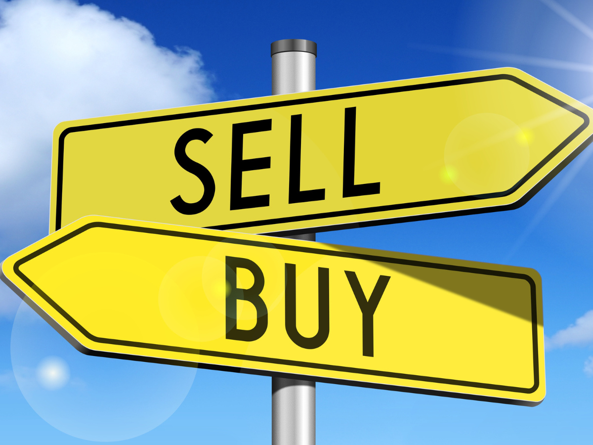 two yellow street signs with the words sell and buy